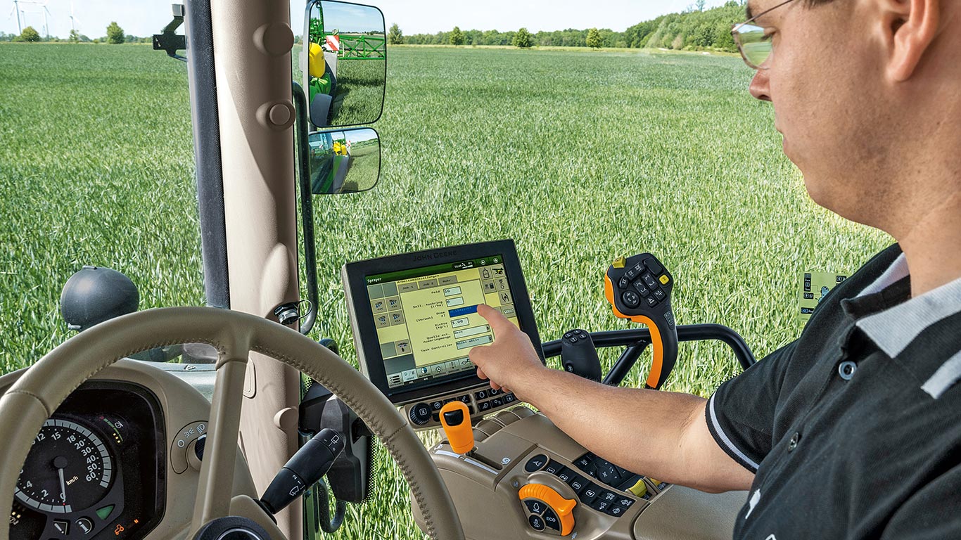 Man in tractor using touchscreen
