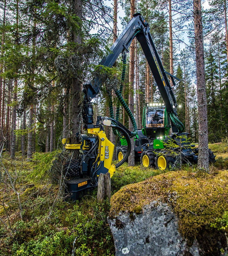 John Deere 1070G and H212 in a forest