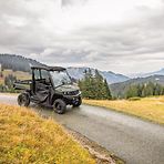 Gator XUV 875M driving on a rural road